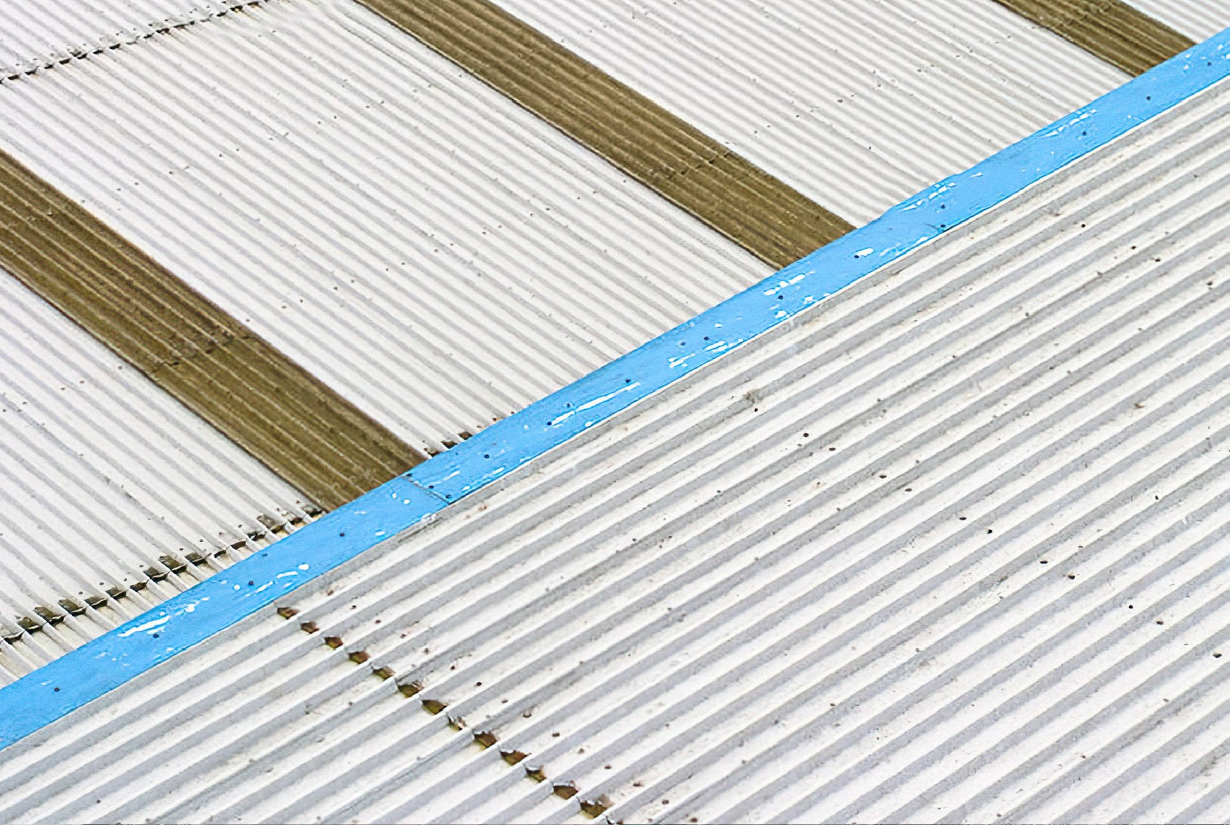 Roof sheet edges mid-treatment with sealed lap joints