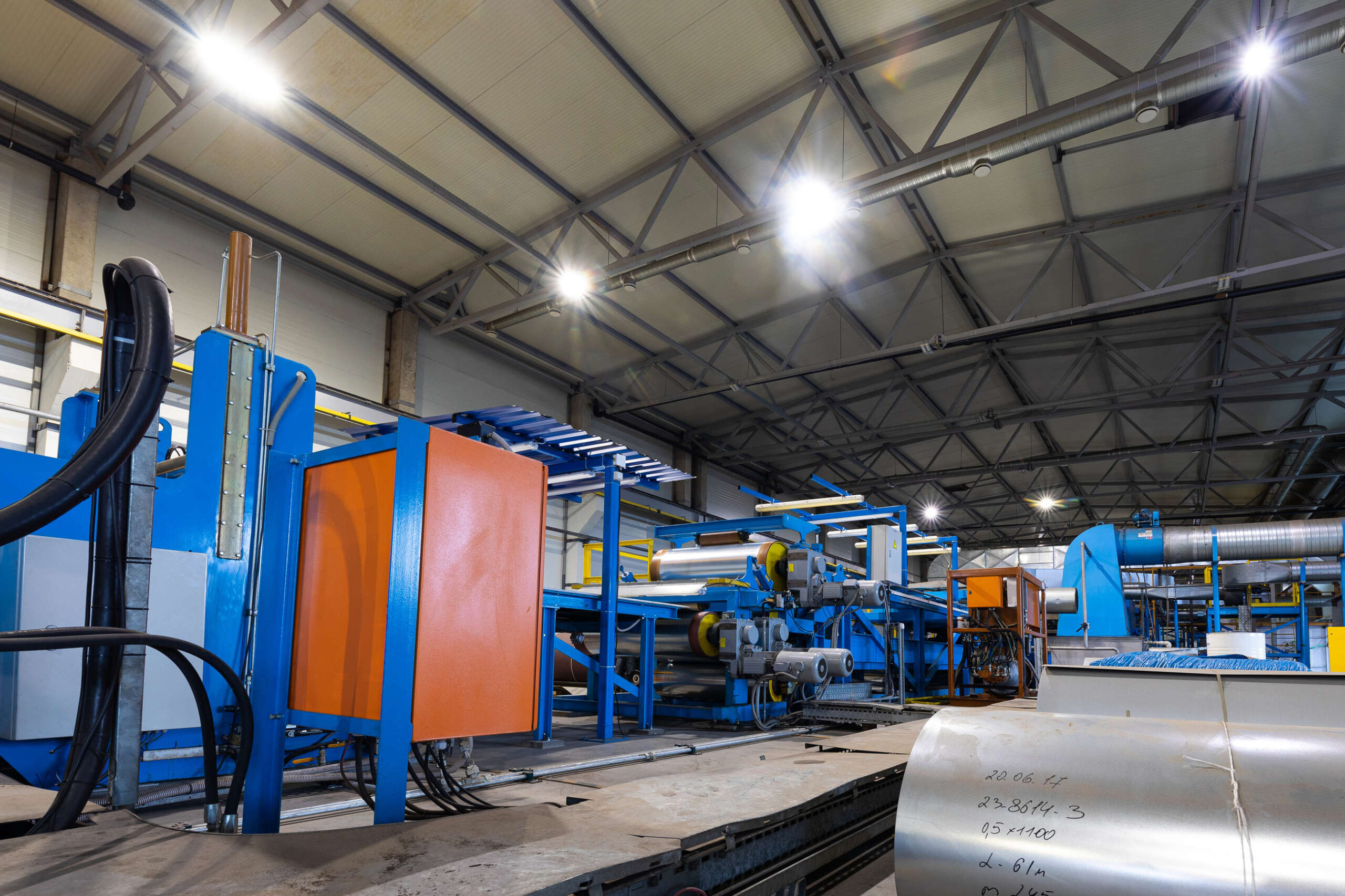 Production hall interior with machinery under protective masking