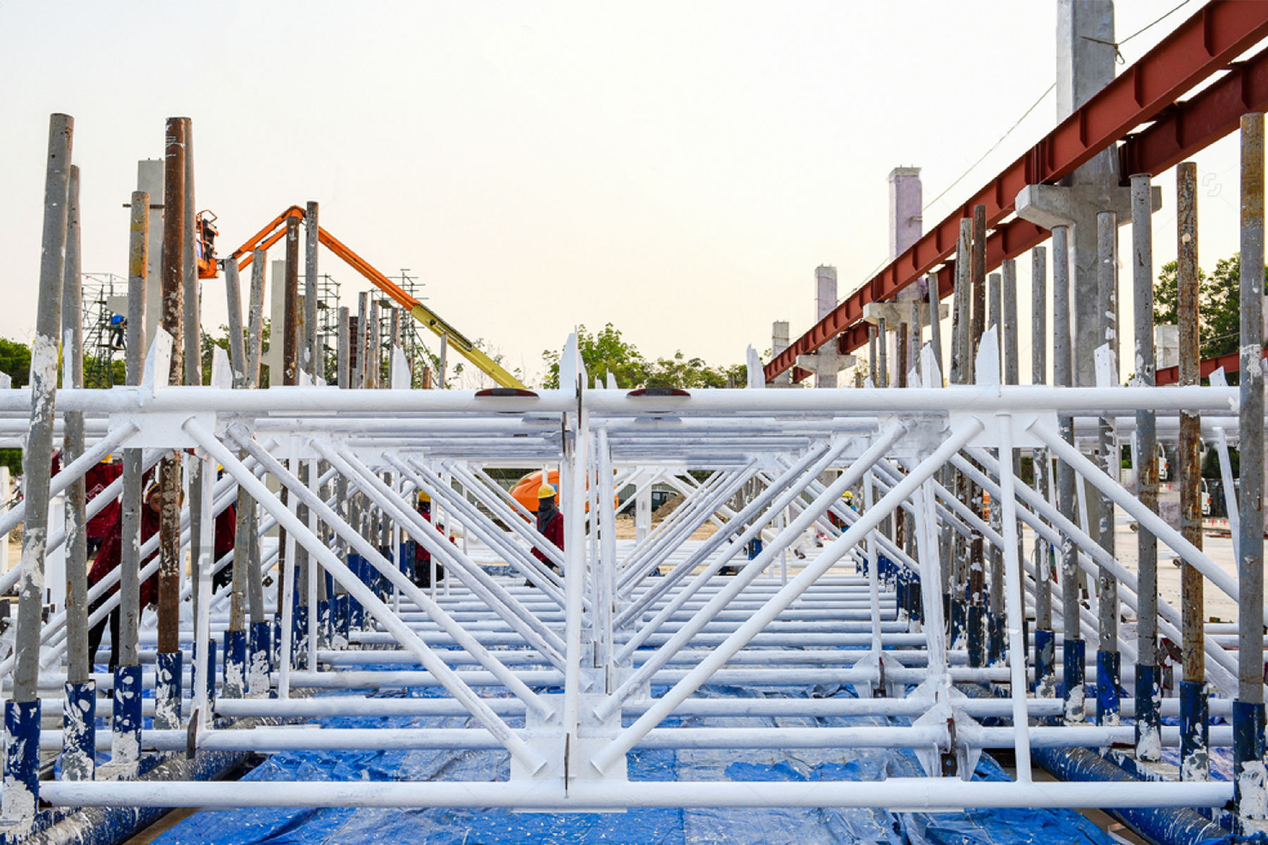 White intumescent-coated steel trusses before installation