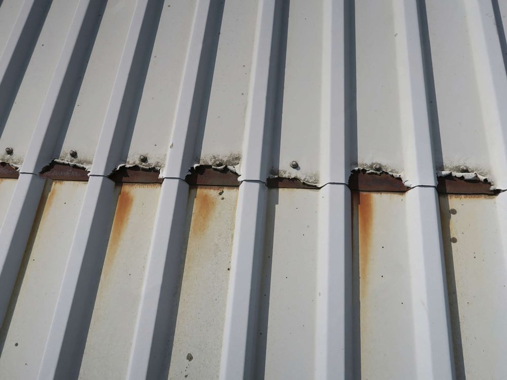 Close-up of cut edge corrosion on a profiled metal roof sheet